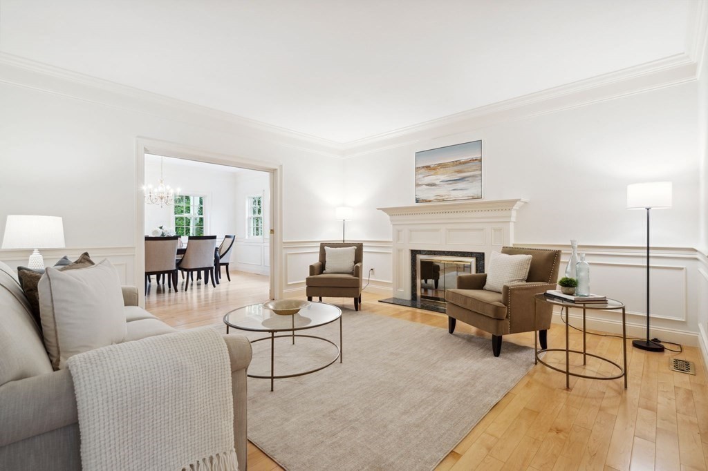 38 Pheasant Lane Manchester, NH 03109 - Photo 8 of 42 a living room with furniture a fireplace and a table