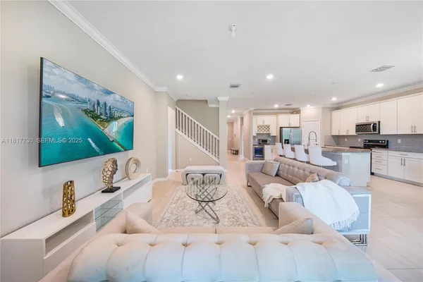 a living room with furniture and a flat screen tv