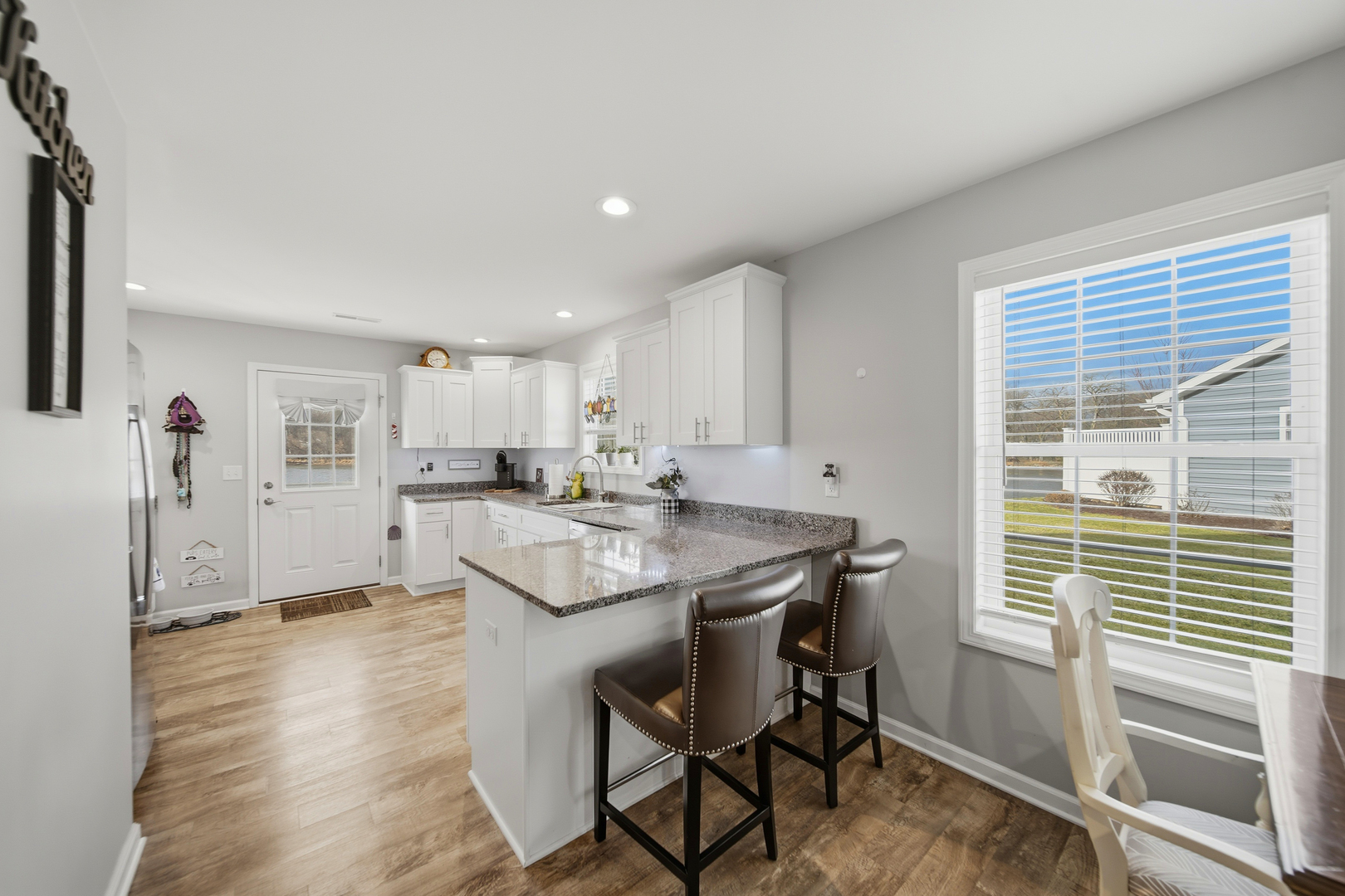 1525 Eadens Place Dixon, IL 61021 - Photo 12 of 30 a kitchen with stainless steel appliances granite countertop a sink and a refrigerator