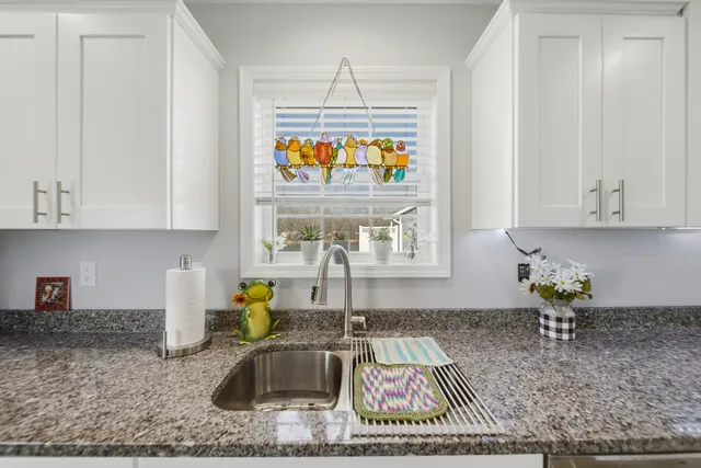 a kitchen with sink cabinets and window