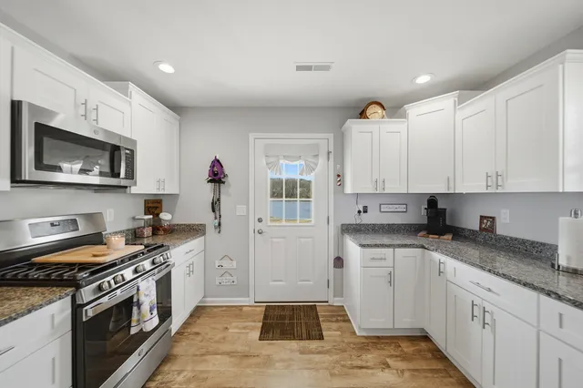 a kitchen with a refrigerator and a stove top oven