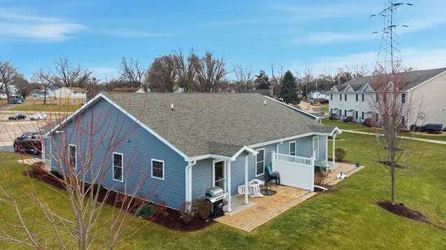 a aerial view of a house next to a yard