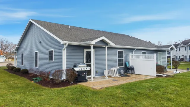 a front view of house with yard and outdoor seating