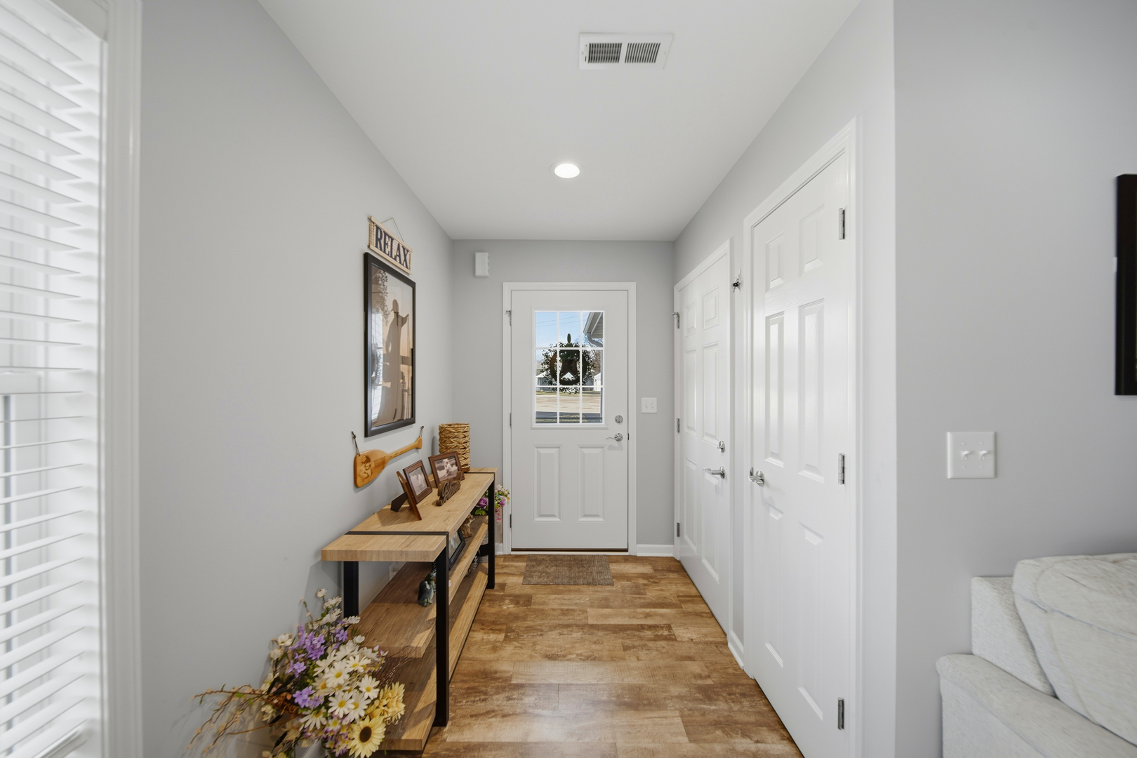 1525 Eadens Place Dixon, IL 61021 - Photo 10 of 30 a view of a hallway with wooden floor and a livingroom