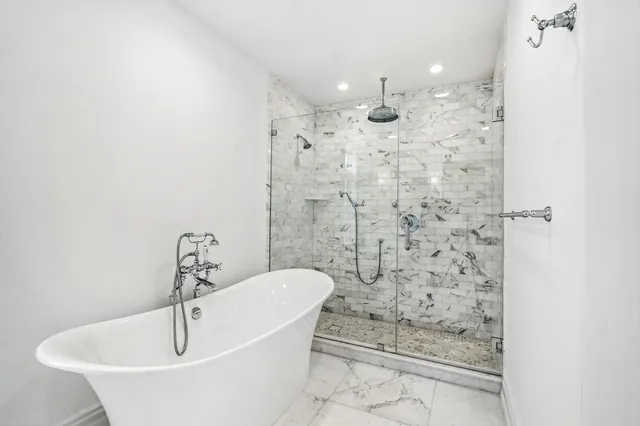 a bathroom with a bathtub and shower