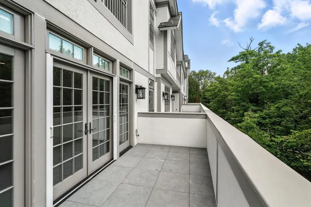 a view of balcony with lots of green space