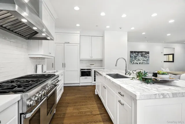 a kitchen with white cabinets and appliances