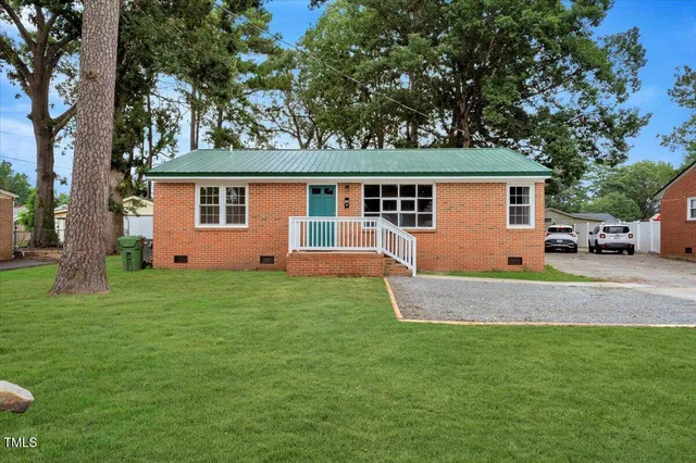 a front view of house with yard and green space