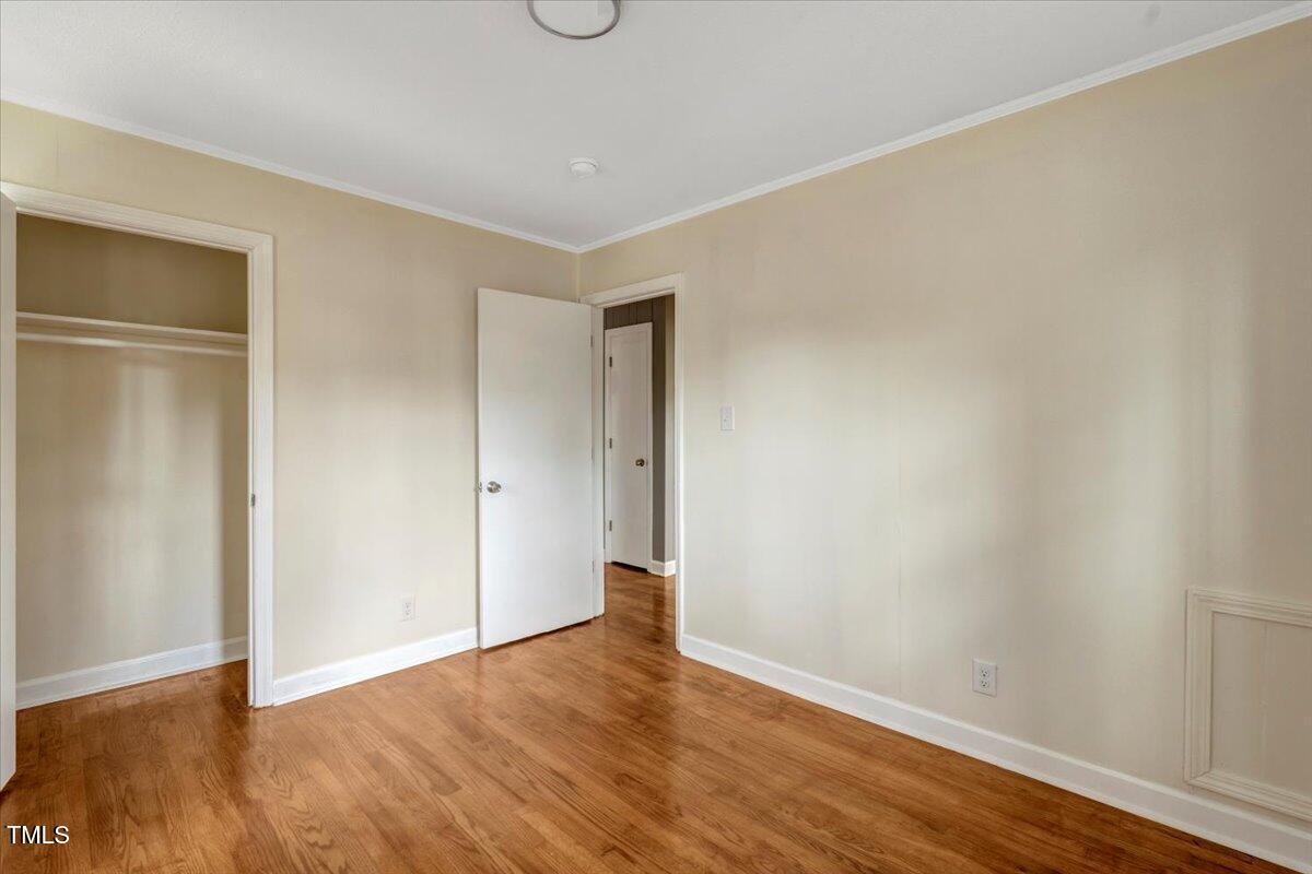 712 East 13th Street Roanoke Rapids, NC 27870 - Photo 32 of 46 a view of an empty room with wooden floor and closet