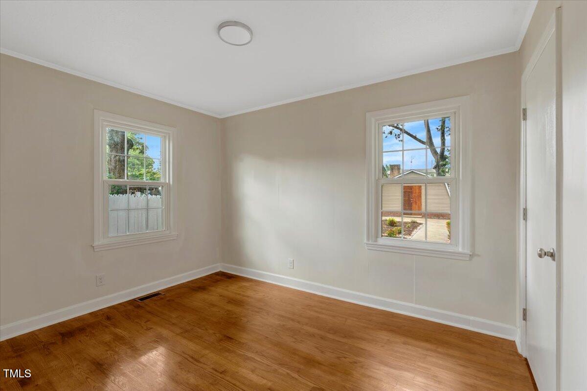 712 East 13th Street Roanoke Rapids, NC 27870 - Photo 33 of 46 a view of an empty room with wooden floor and a window
