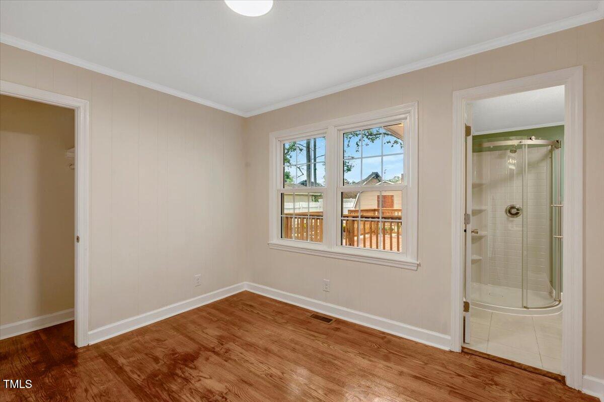 712 East 13th Street Roanoke Rapids, NC 27870 - Photo 36 of 46 a view of an empty room with wooden floor and a window