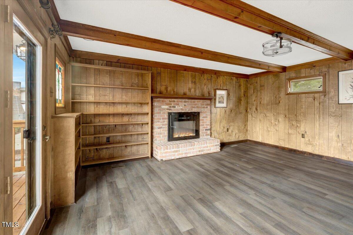 712 East 13th Street Roanoke Rapids, NC 27870 - Photo 40 of 46 a view of a livingroom with a fireplace a ceiling fan and window