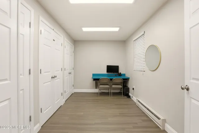 a view of a room with wooden floor lounge chair and windows