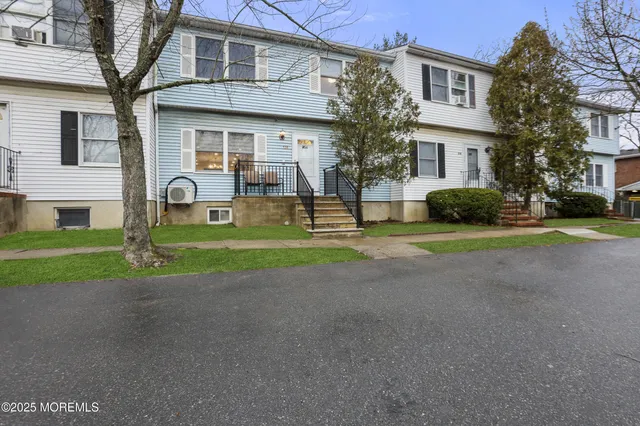 a view of a house with a yard and plants