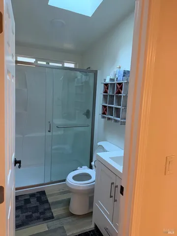 a bathroom with a toilet a sink and shower