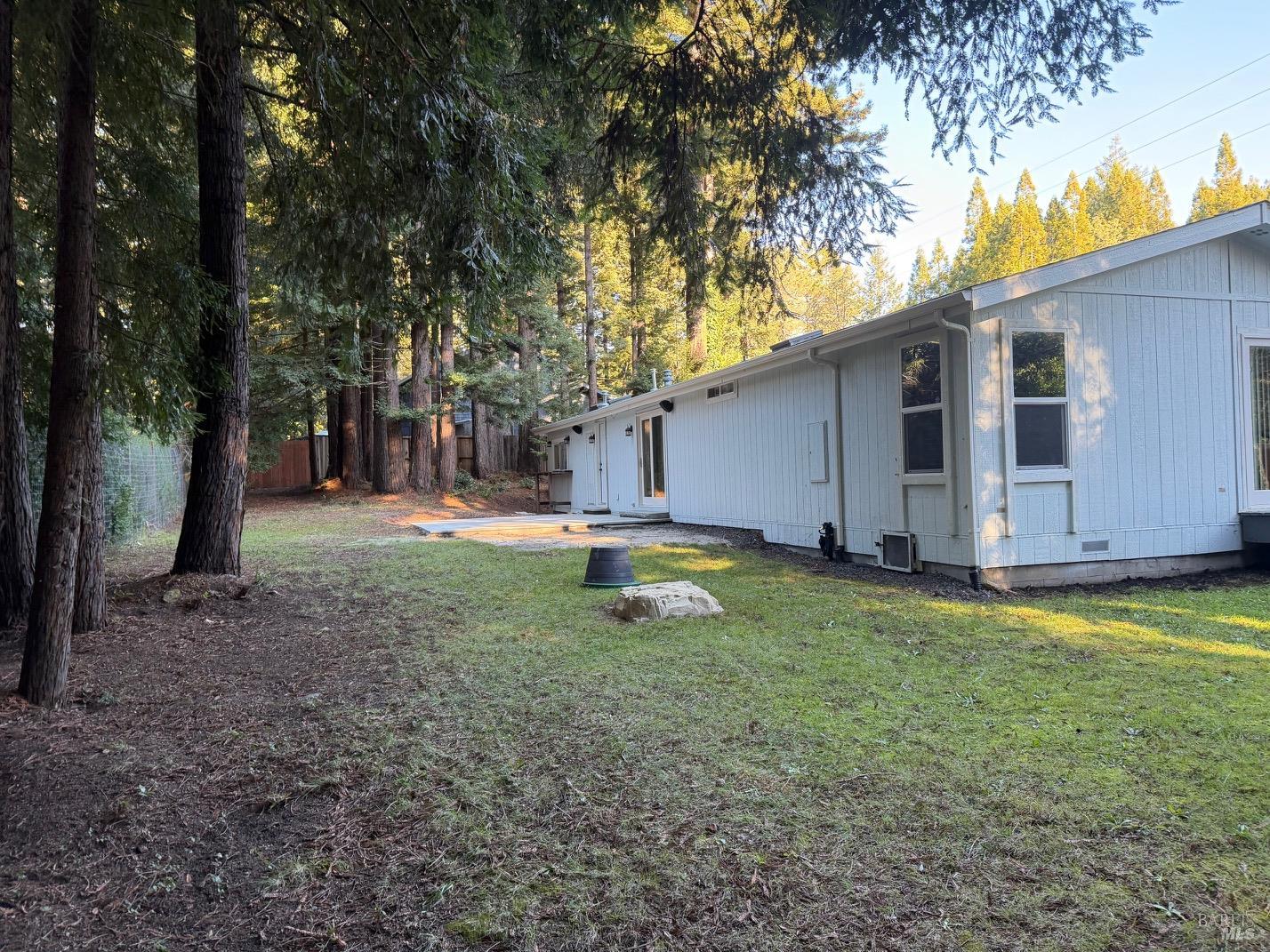 38350 Old Stage Road Gualala, CA 95445 - Photo 15 of 23 a view of a backyard with large trees and wooden fence