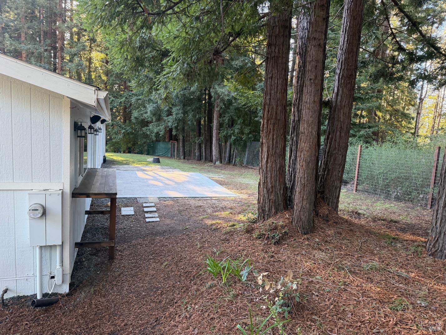 38350 Old Stage Road Gualala, CA 95445 - Photo 18 of 23 a view of a backyard with large trees and a small barn