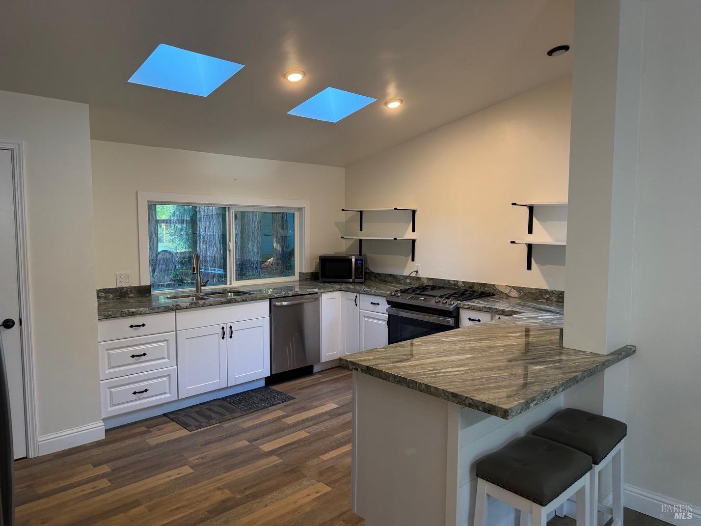38350 Old Stage Road Gualala, CA 95445 - Photo 3 of 23 a kitchen with granite countertop a stove and a sink