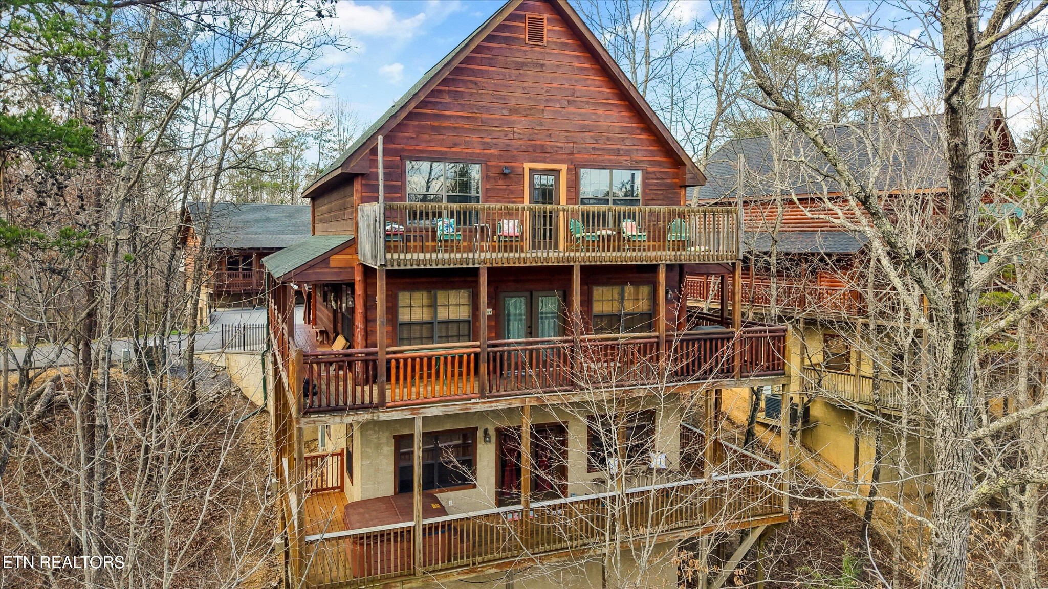 a view of a house with large windows and wooden fence