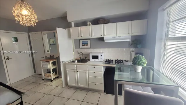a kitchen with stainless steel appliances granite countertop a refrigerator sink and cabinets