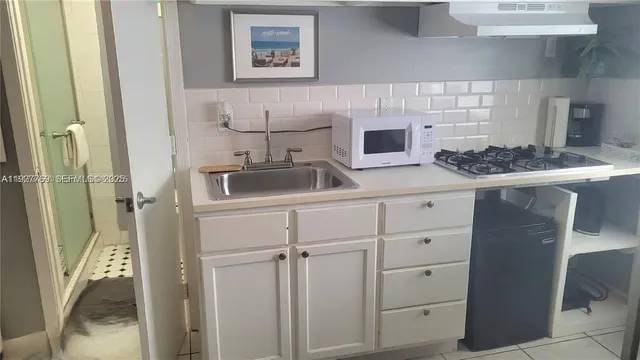 a kitchen with sink cabinets and stove