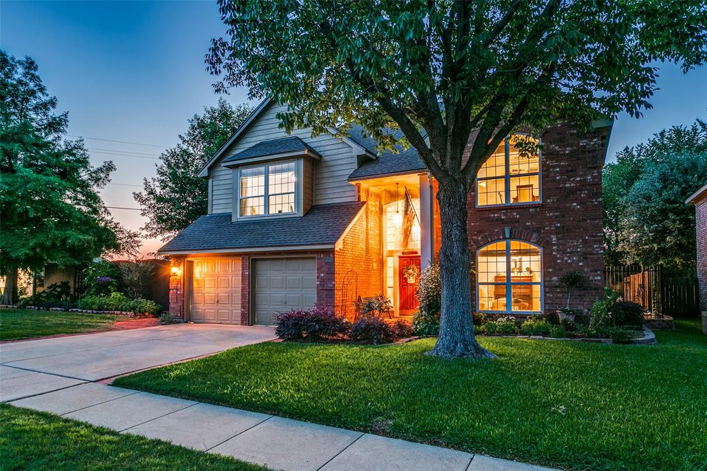 a house view with a garden and trees