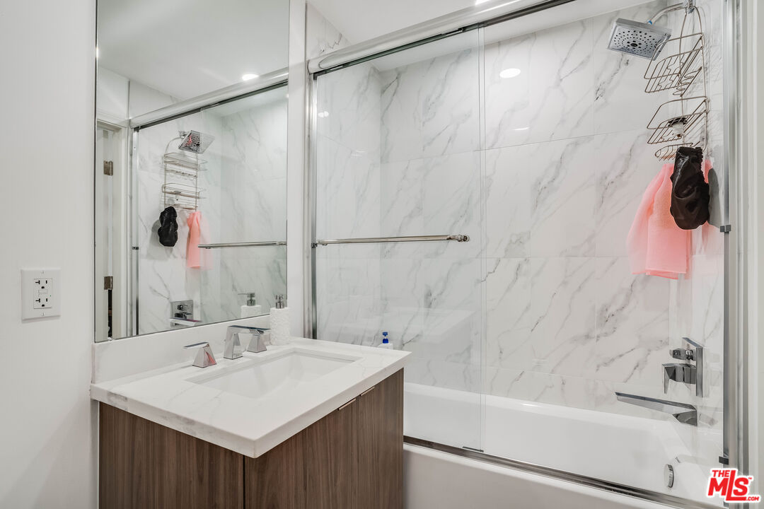 1021 South Shenandoah Street, Unit 101 Los Angeles, CA 90035 - Photo 12 of 18 a bathroom with a sink and a mirror