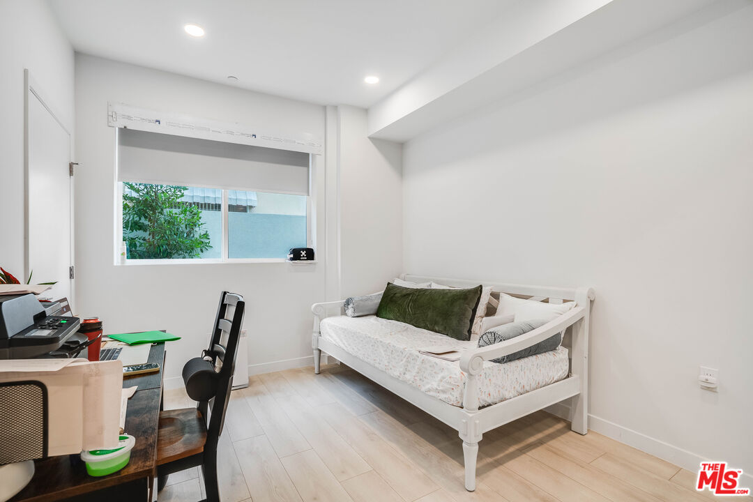 1021 South Shenandoah Street, Unit 101 Los Angeles, CA 90035 - Photo 13 of 18 a living room with furniture and wooden floor