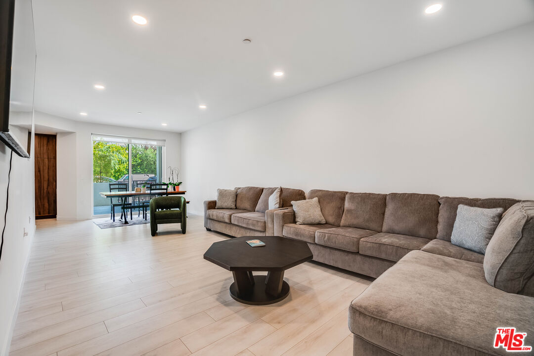 1021 South Shenandoah Street, Unit 101 Los Angeles, CA 90035 - Photo 3 of 18 a living room with furniture and view of kitchen