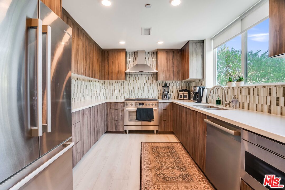 1021 South Shenandoah Street, Unit 101 Los Angeles, CA 90035 - Photo 5 of 18 a kitchen with counter top space and wooden floor