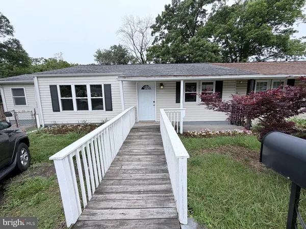 a front view of house with deck and yard