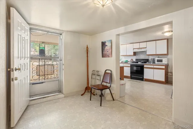 a living room with stainless steel appliances granite countertop furniture and a kitchen view