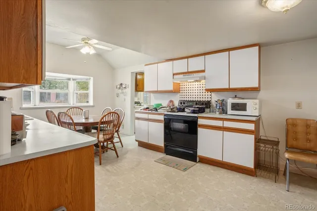 a kitchen with stainless steel appliances granite countertop sink stove top oven and cabinets