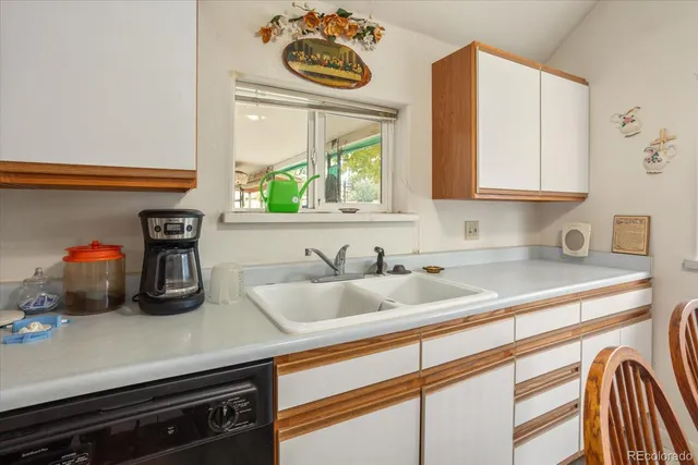 a kitchen with a sink cabinets and a window