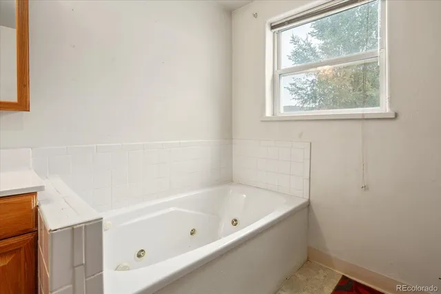 a white bath tub sitting next to a window