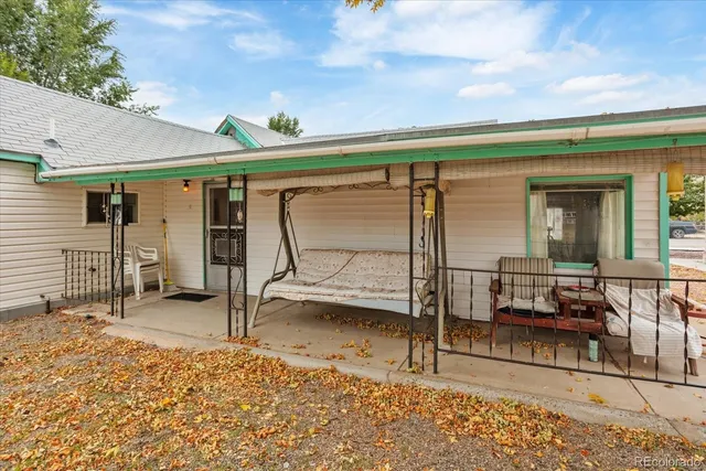 a view of a porch with a table and chairs