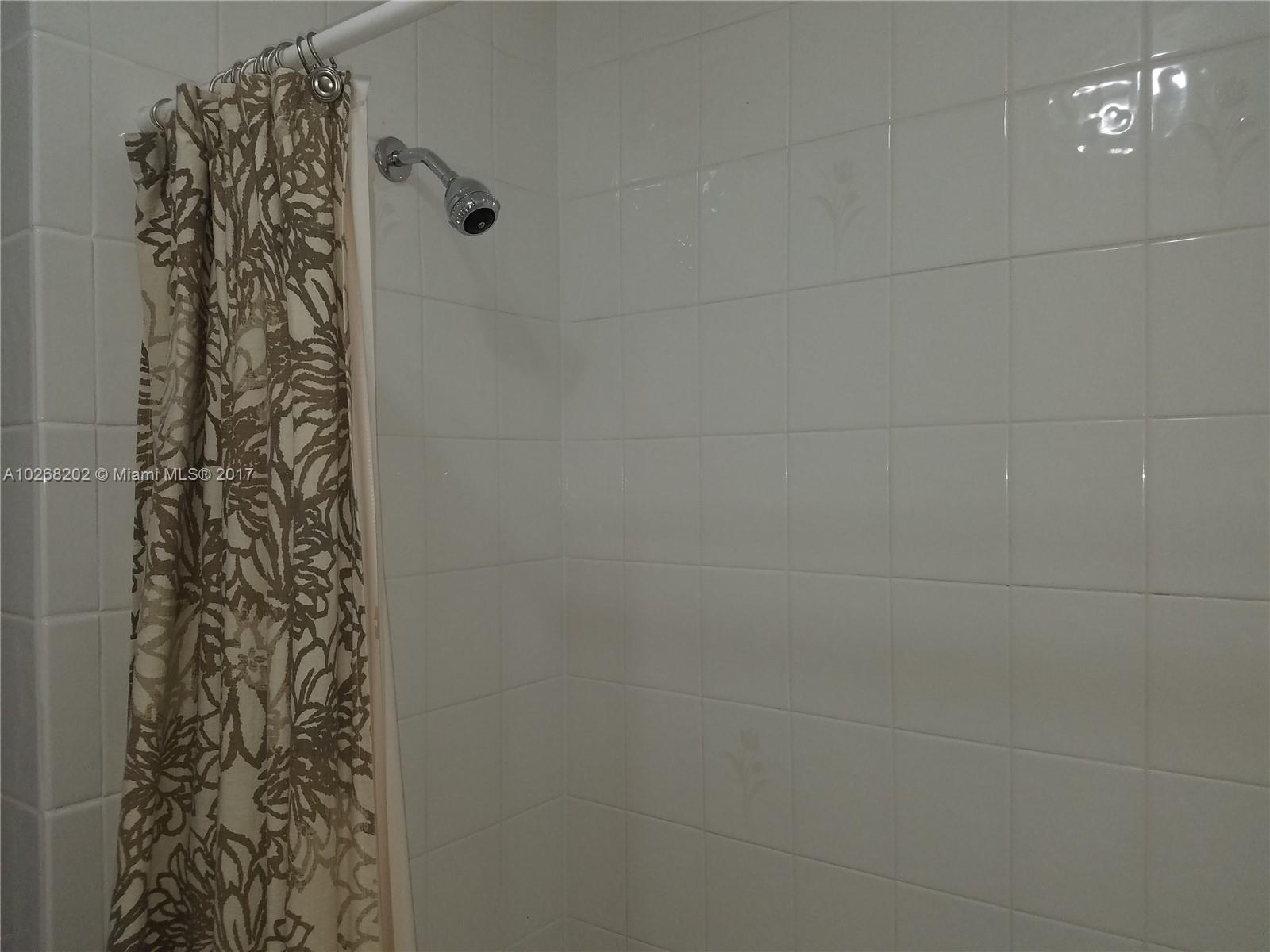 3091 Southwest 84th Court Miami, FL 33155 - Photo 18 of 24 a bathroom with a shower curtain and a shower curtain