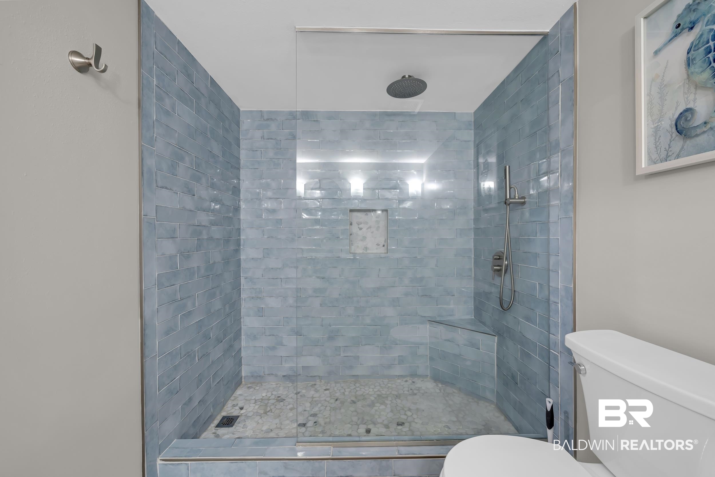 14100 River Road, Unit 211 Pensacola, FL 32507 - Photo 29 of 56 Walk-in shower featuring blue subway tile, a built-in shower bench, a recessed niche, and a glass enclosure