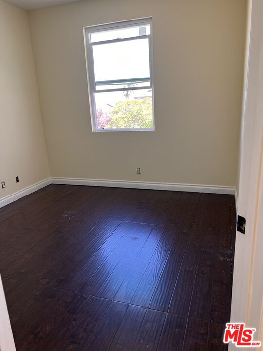 40247 Preston Road Palmdale, CA 93551 - Photo 11 of 15 an empty room with wooden floor and windows