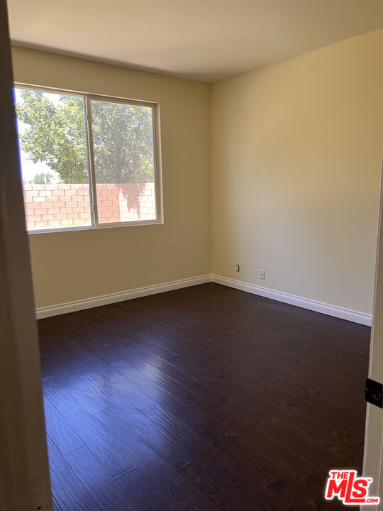 40247 Preston Road Palmdale, CA 93551 - Photo 14 of 15 an empty room with wooden floor and windows