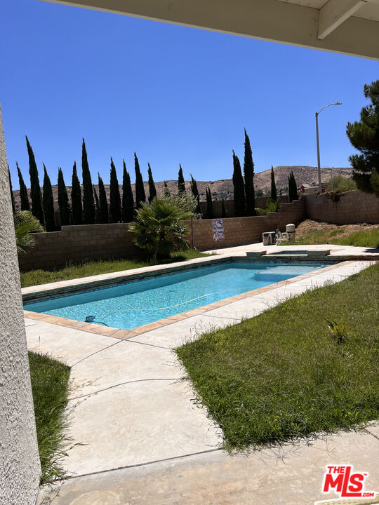 40247 Preston Road Palmdale, CA 93551 - Photo 15 of 15 a view of a swimming pool with an outdoor space and seating area