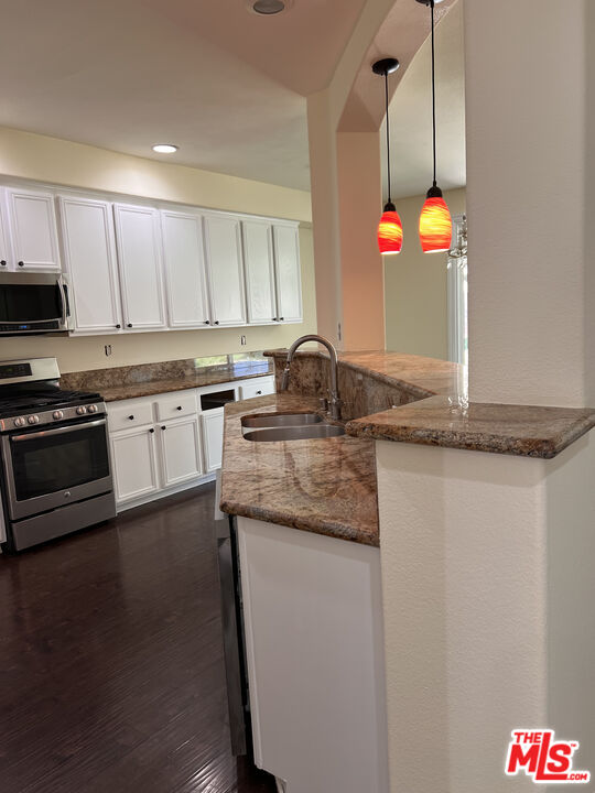 40247 Preston Road Palmdale, CA 93551 - Photo 6 of 15 a kitchen with stainless steel appliances granite countertop a sink a stove and a microwave