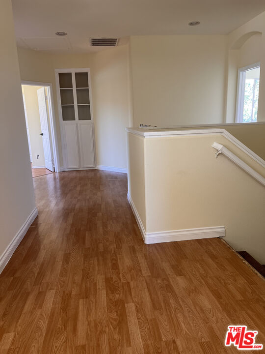 40247 Preston Road Palmdale, CA 93551 - Photo 7 of 15 an empty room with wooden floor and windows