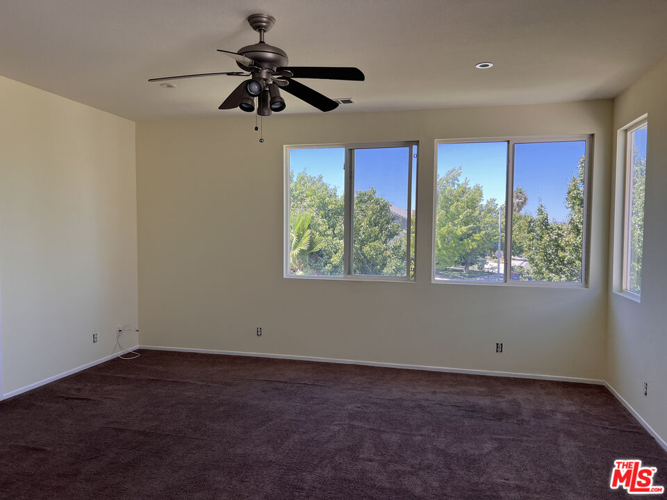40247 Preston Road Palmdale, CA 93551 - Photo 10 of 15 a view of a livingroom with a ceiling fan and window