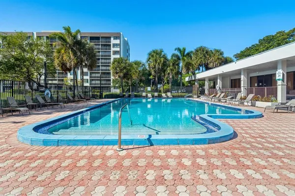 a view of a house with swimming pool and sitting area