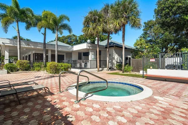 a view of a patio with a table chairs and backyard