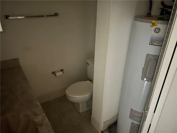 a white toilet sitting next to a sink