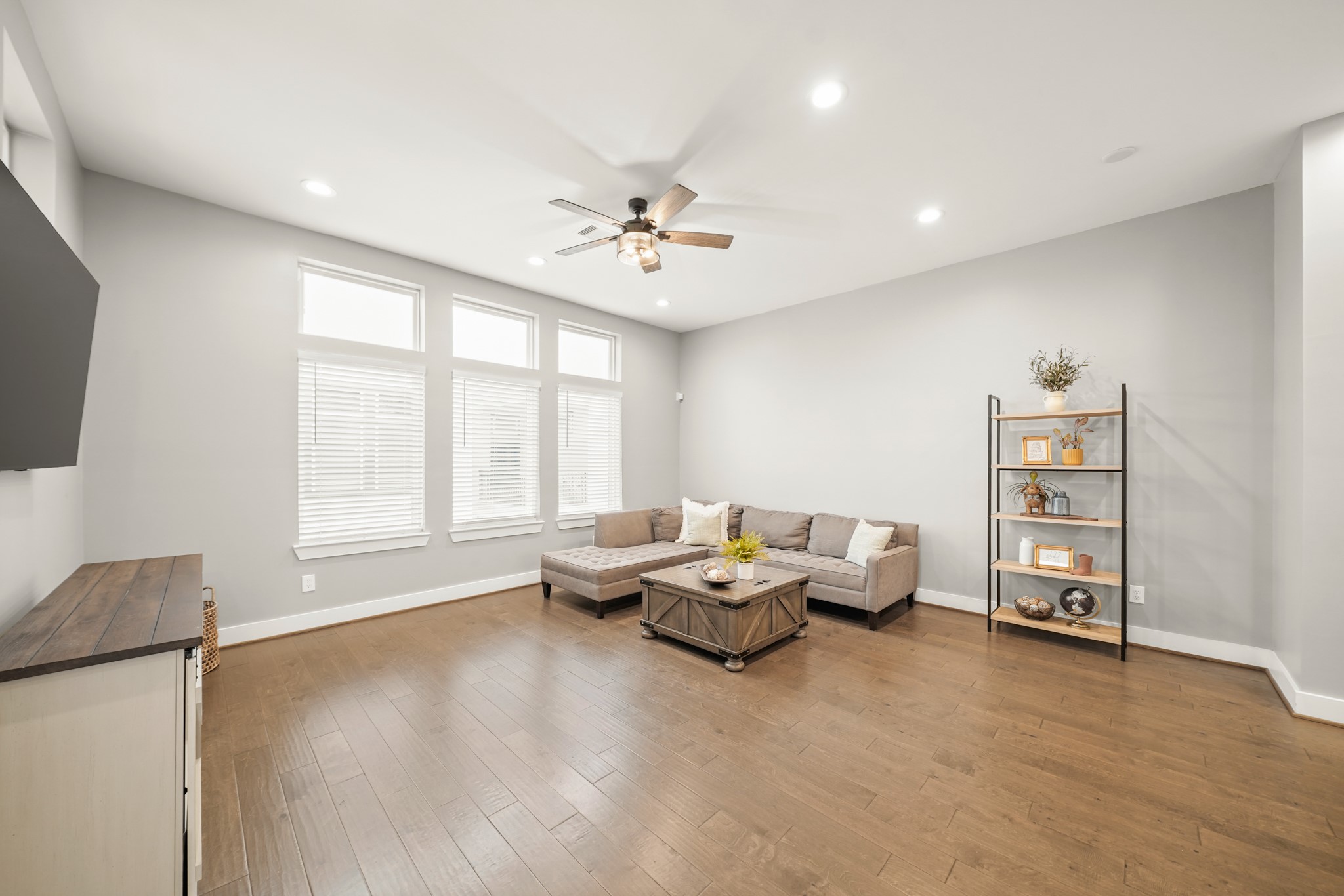 720 West Donovan Street Houston, TX 77091 - Photo 5 of 42 The living room includes a high ceiling with recessed lighting, a ceiling fan with lights and hardwood floors. The interior was painted on 2025.