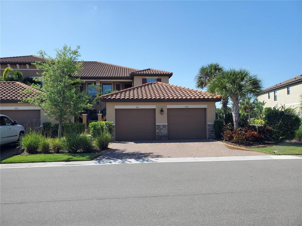 a front view of a house with a yard and garage