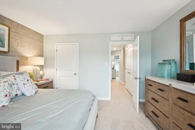 a bedroom with a bed and a dresser